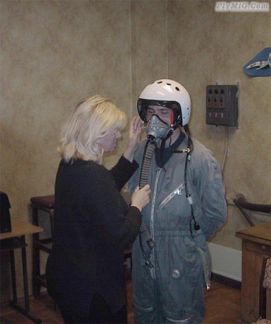 Checking and adjusting oxygen mask and flight helm...